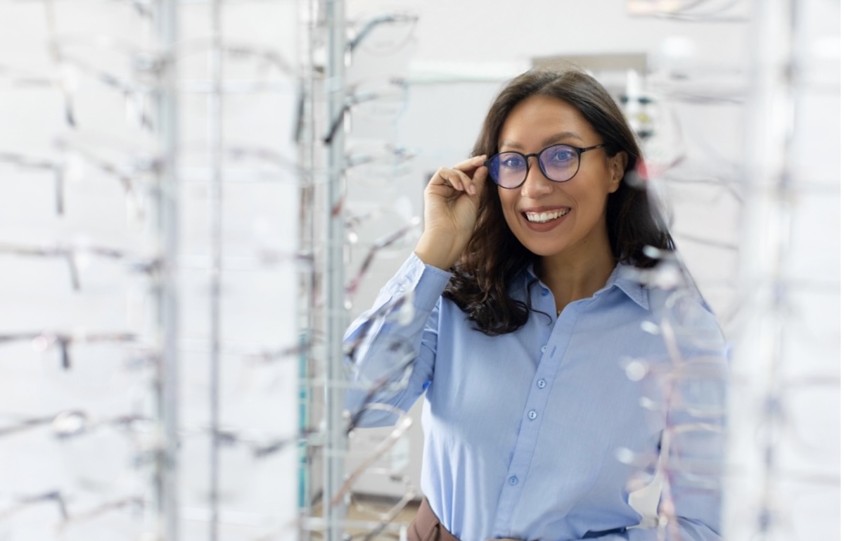 A person trying on glasses at their optometrist's office.